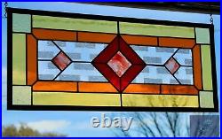 Contemporary stained glass panel with amber and red tones. Decorative window
