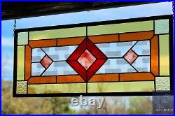 Contemporary stained glass panel with amber and red tones. Decorative window