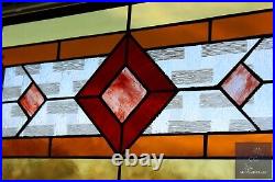 Contemporary stained glass panel with amber and red tones. Decorative window