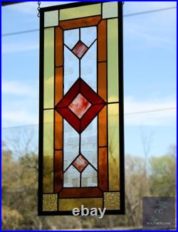 Contemporary stained glass panel with amber and red tones. Decorative window