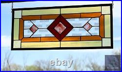 Contemporary stained glass panel with amber and red tones. Decorative window